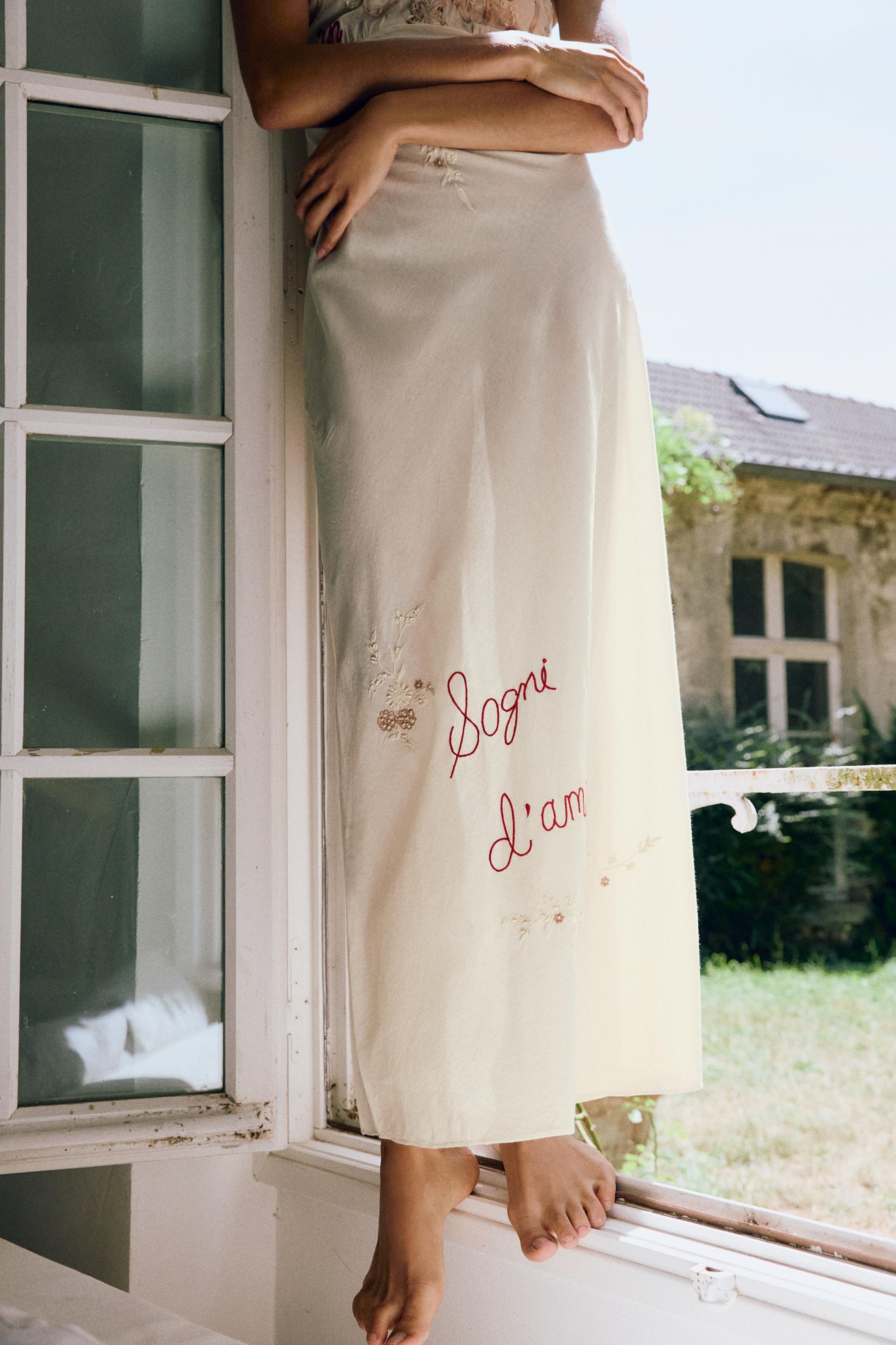 DRESS WITH EMBROIDERY, TEXT, AND BEADING